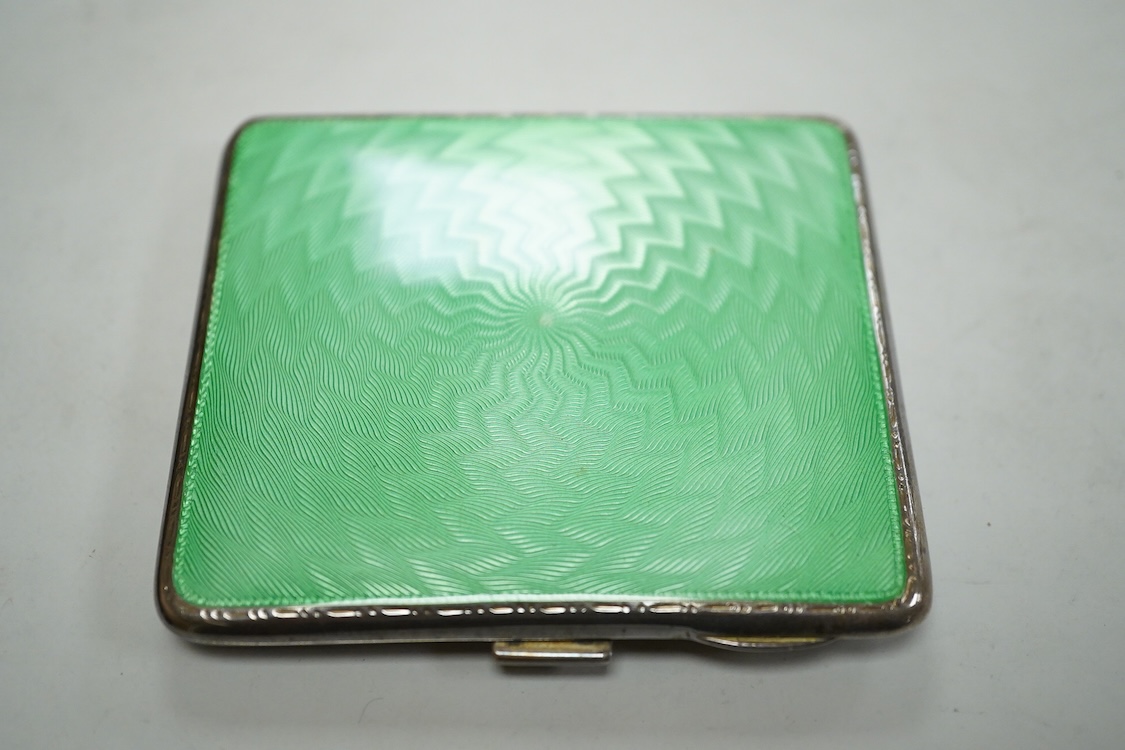 A George V engine turned silver and green enamel cigarette case, by Mappin & Webb, Birmingham, 1932, 82mm and a cased set of six silver handled tea knives.